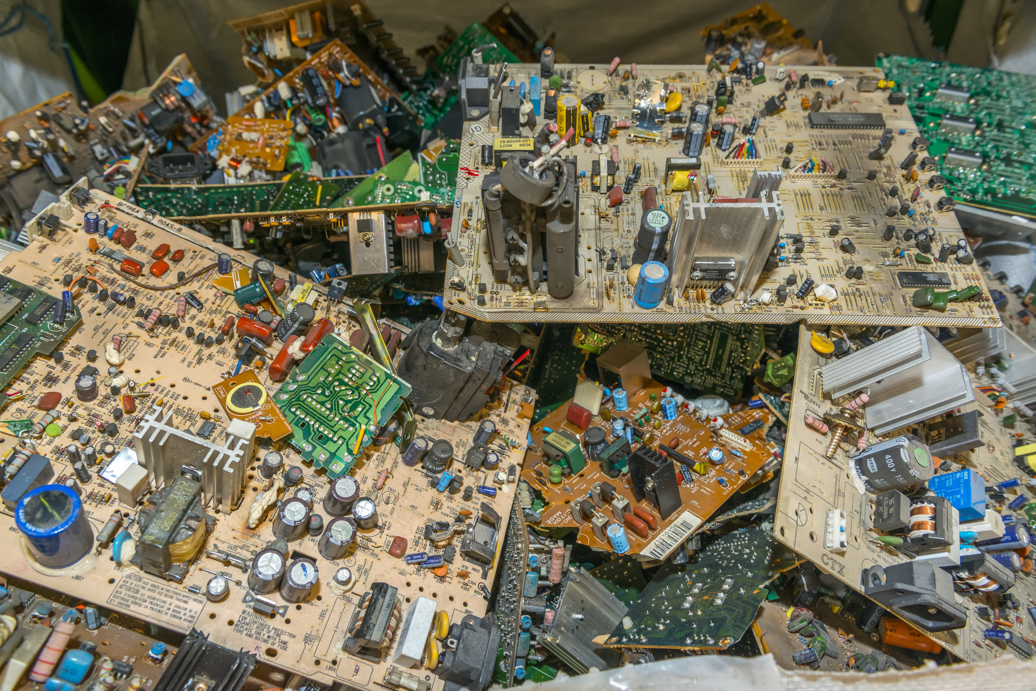 Pile of assorted electronic circuit boards.